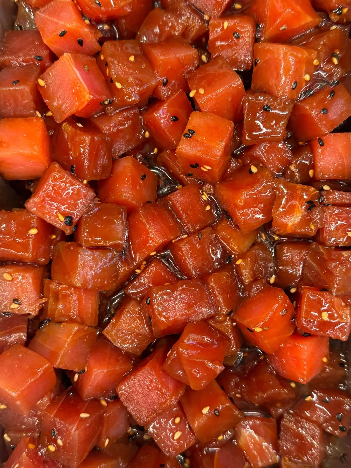 Ahi tuna poke: cubes of marinated raw tuna with sesame seeds