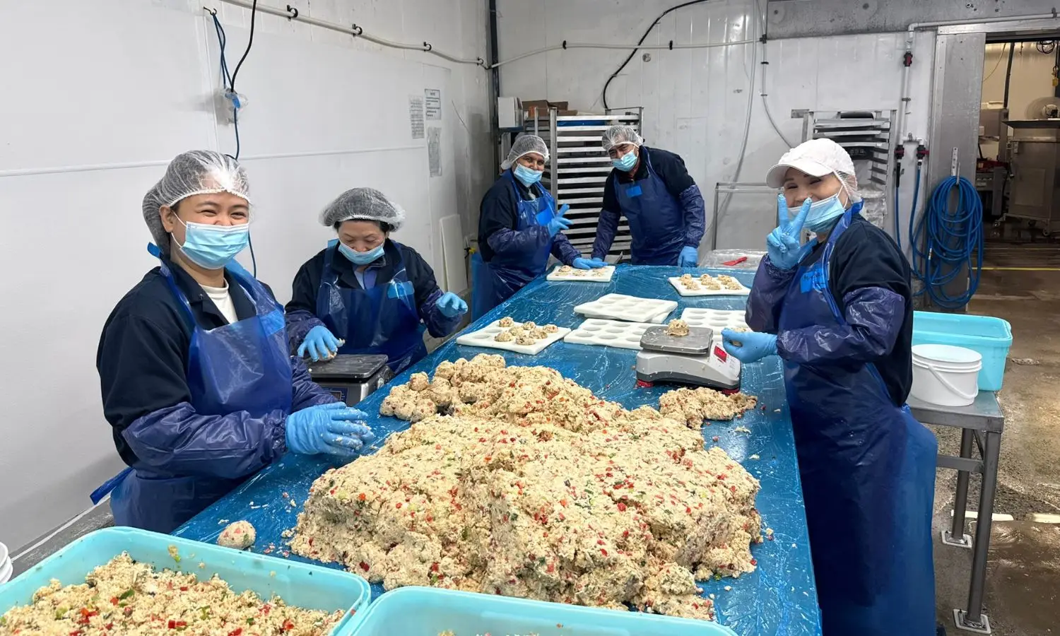 The crab cake production team smiling for the camera