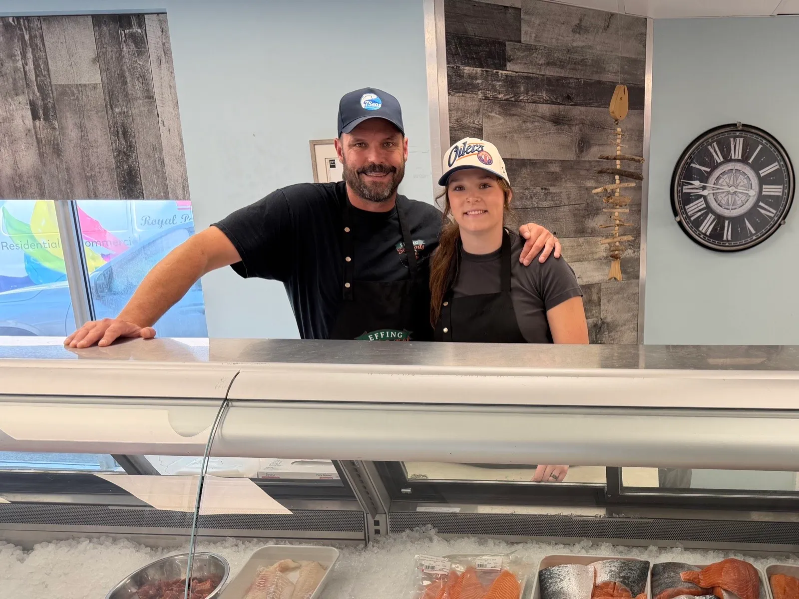 Rob and his daughter Sierra behind the fresh seafood counter at Effing Surf & Turf, our Edmonton retail shop