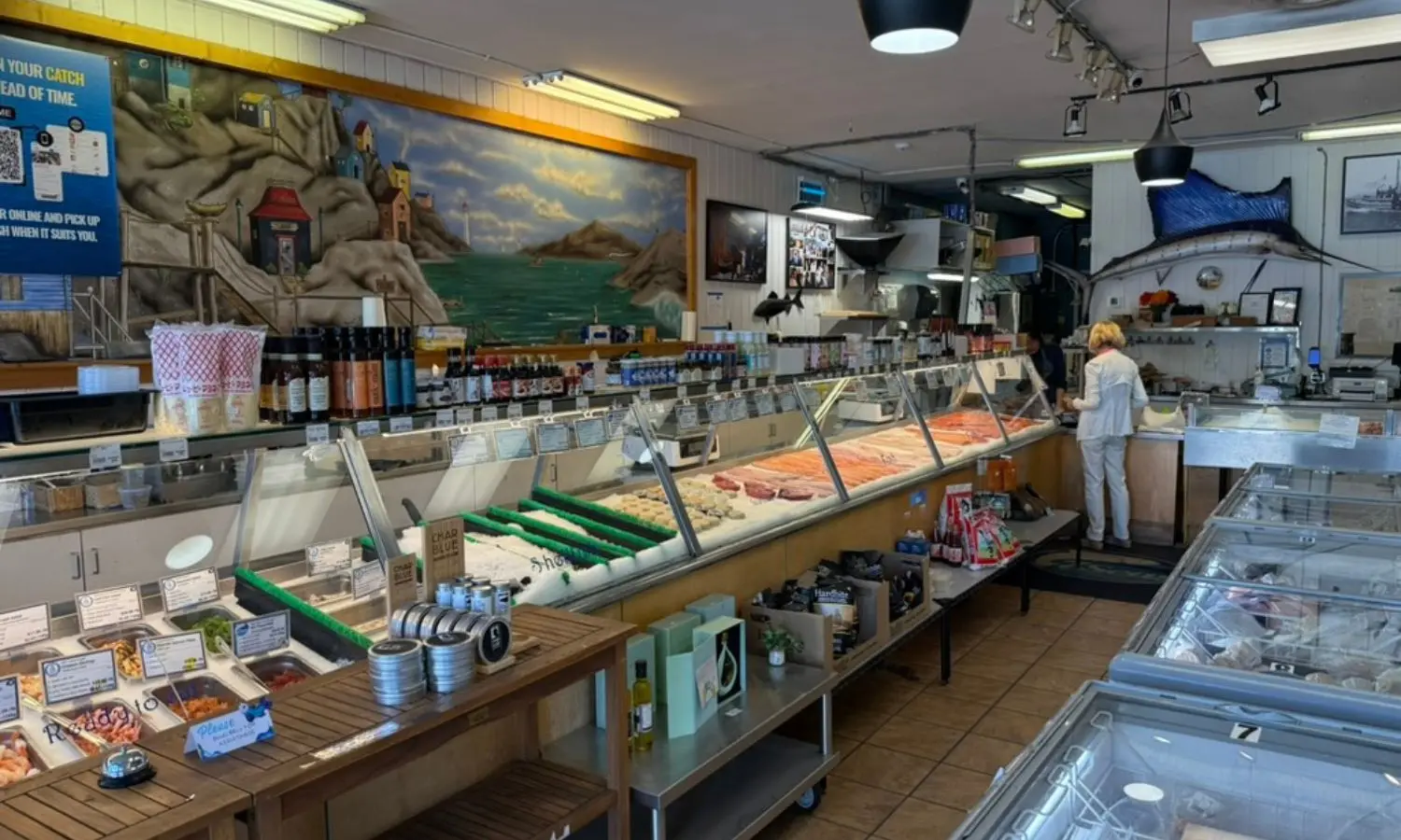The fresh seafood counter at the 7 Seas Fish Market in Kitsilano, with salmon fillets and fresh fish on ice