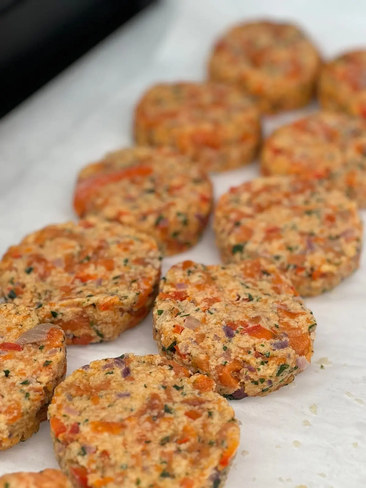 Hand-formed salmon cakes flecked with herbs and red pepper