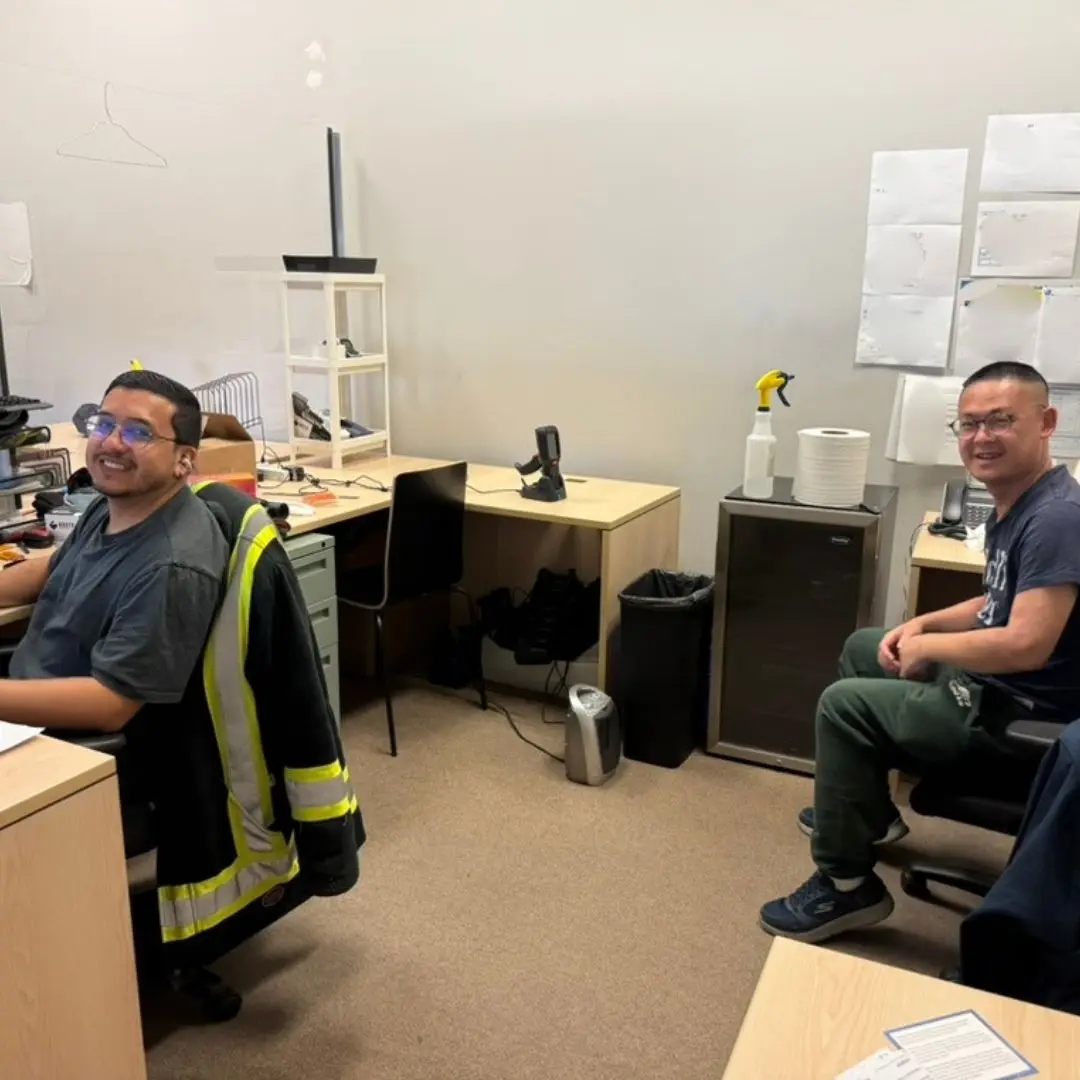Two members of the inventory team smiling for the camera