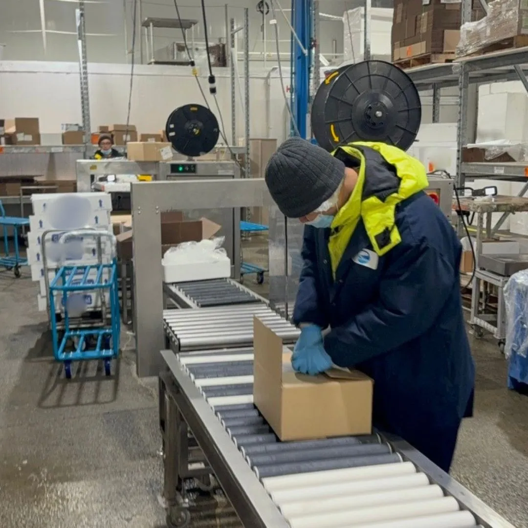 Folding a shipping box at the order assembly station