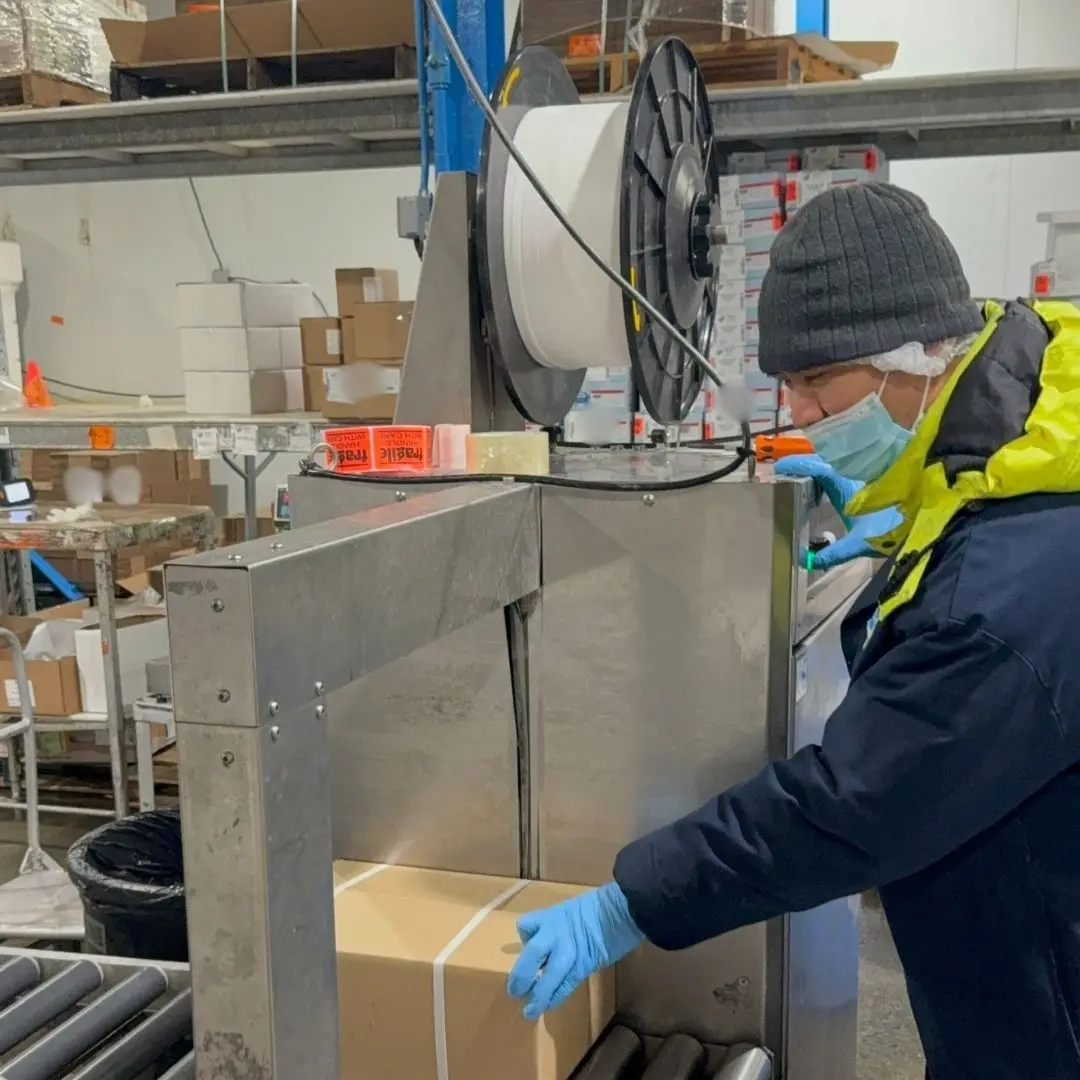 Strapping a packed box closed for delivery