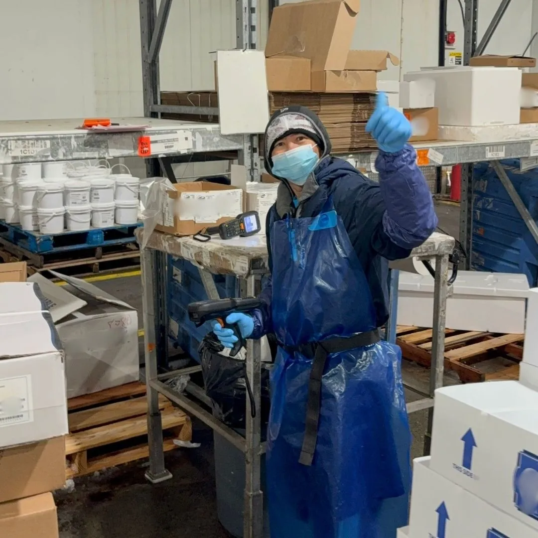 A member of the order assembly team smiling for the camera