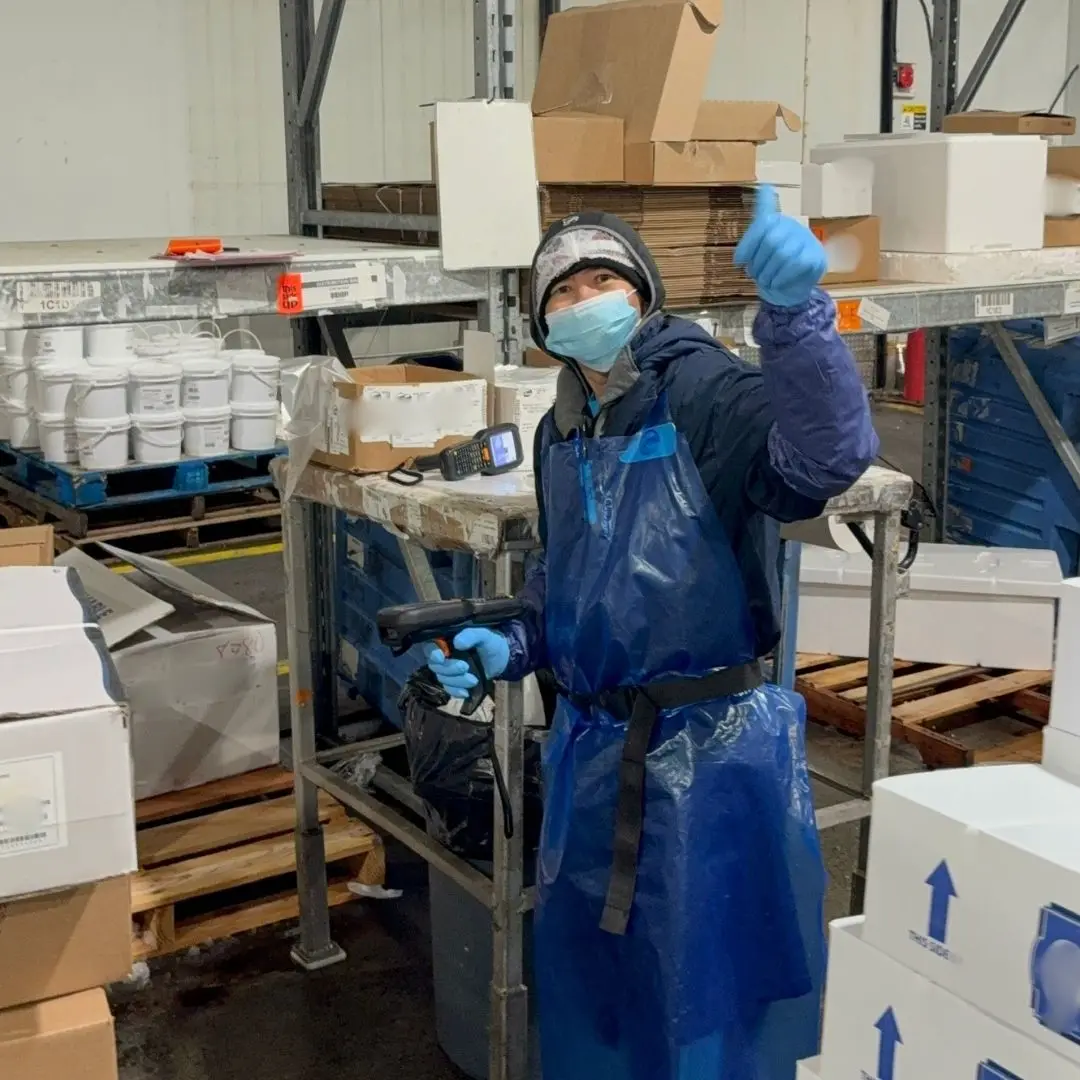 A member of the order assembly team smiling for the camera