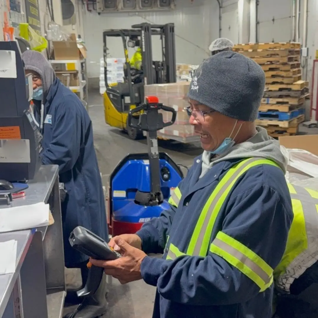 A receiver keying an entry into a handheld scanner at the receiving desk