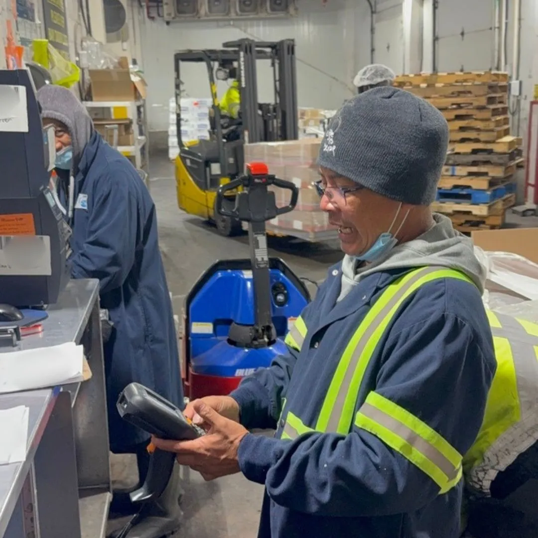A receiver keying an entry into a handheld scanner at the receiving desk