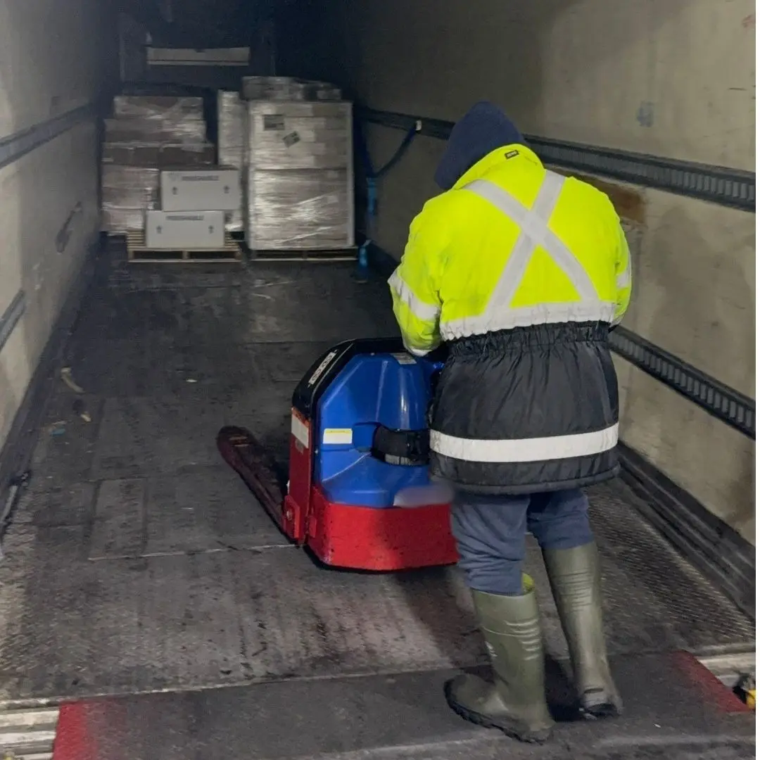Unloading pallets off a truck at the receiving dock of 7 Seas' Richmond, BC facility