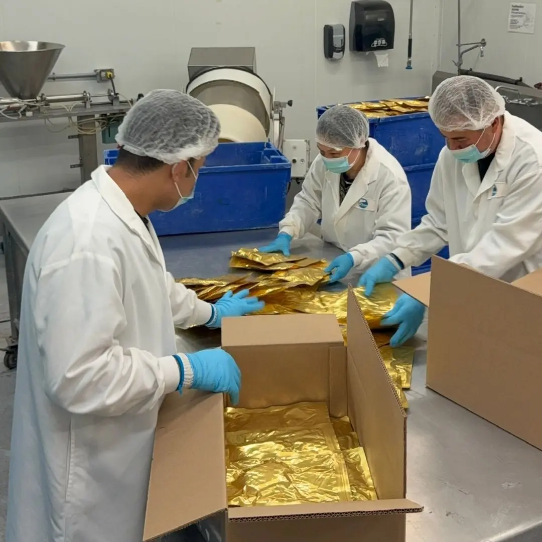 Team member inspecting retort pouches to confirm the seals are shelf-stable