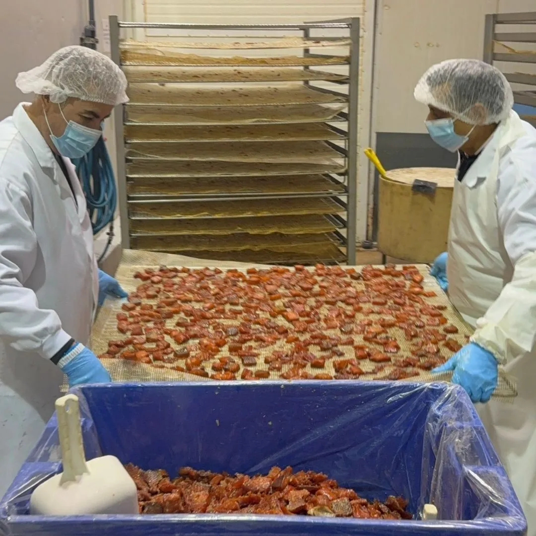 De-racking freshly smoked salmon candy before packaging