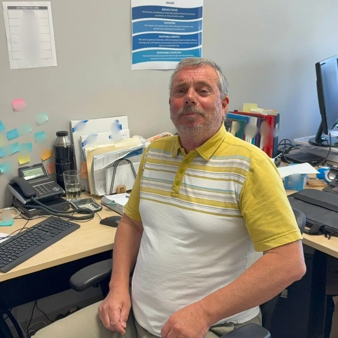 A team member posing for the camera at the 7 Seas office
