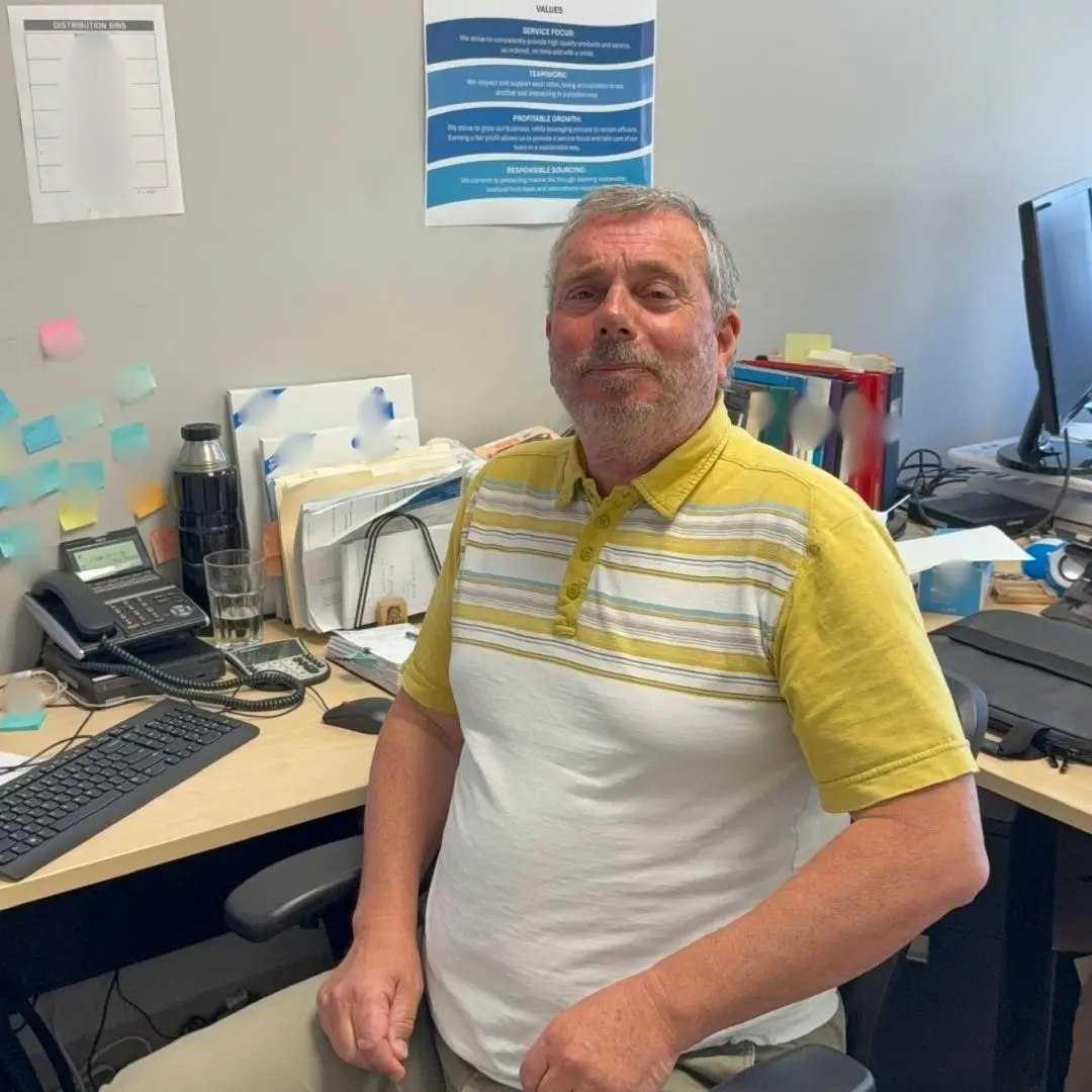 A team member posing for the camera at the 7 Seas office